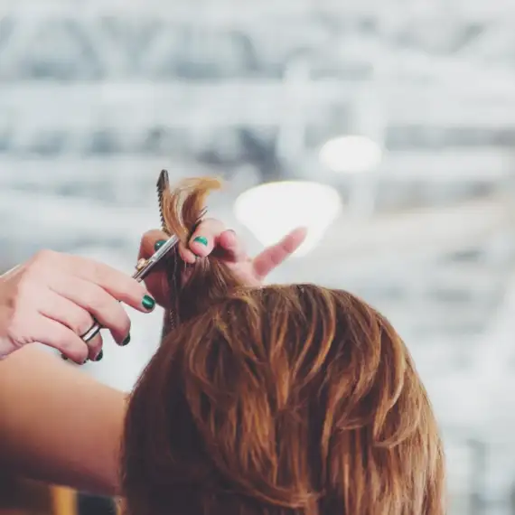 Image of stylist doing a hair cut & style at Lusso Hair Studio & Spa located in Winston-Salem, NC