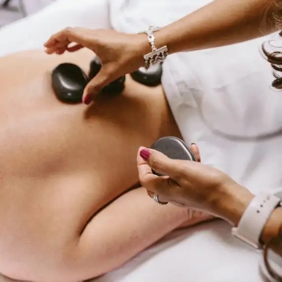Image of a hot stone massage service at Lusso Hair Studio & Spa located in Winston-Salem, NC.